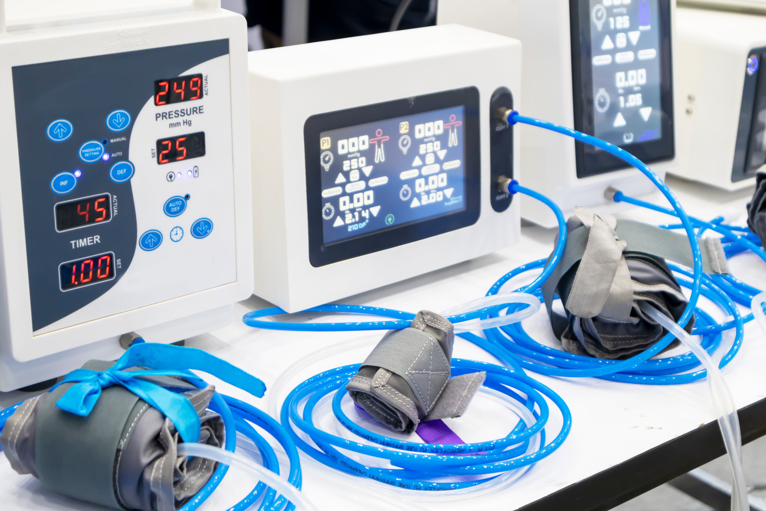 Medical devices with digital displays and connected pressure cuffs on a table